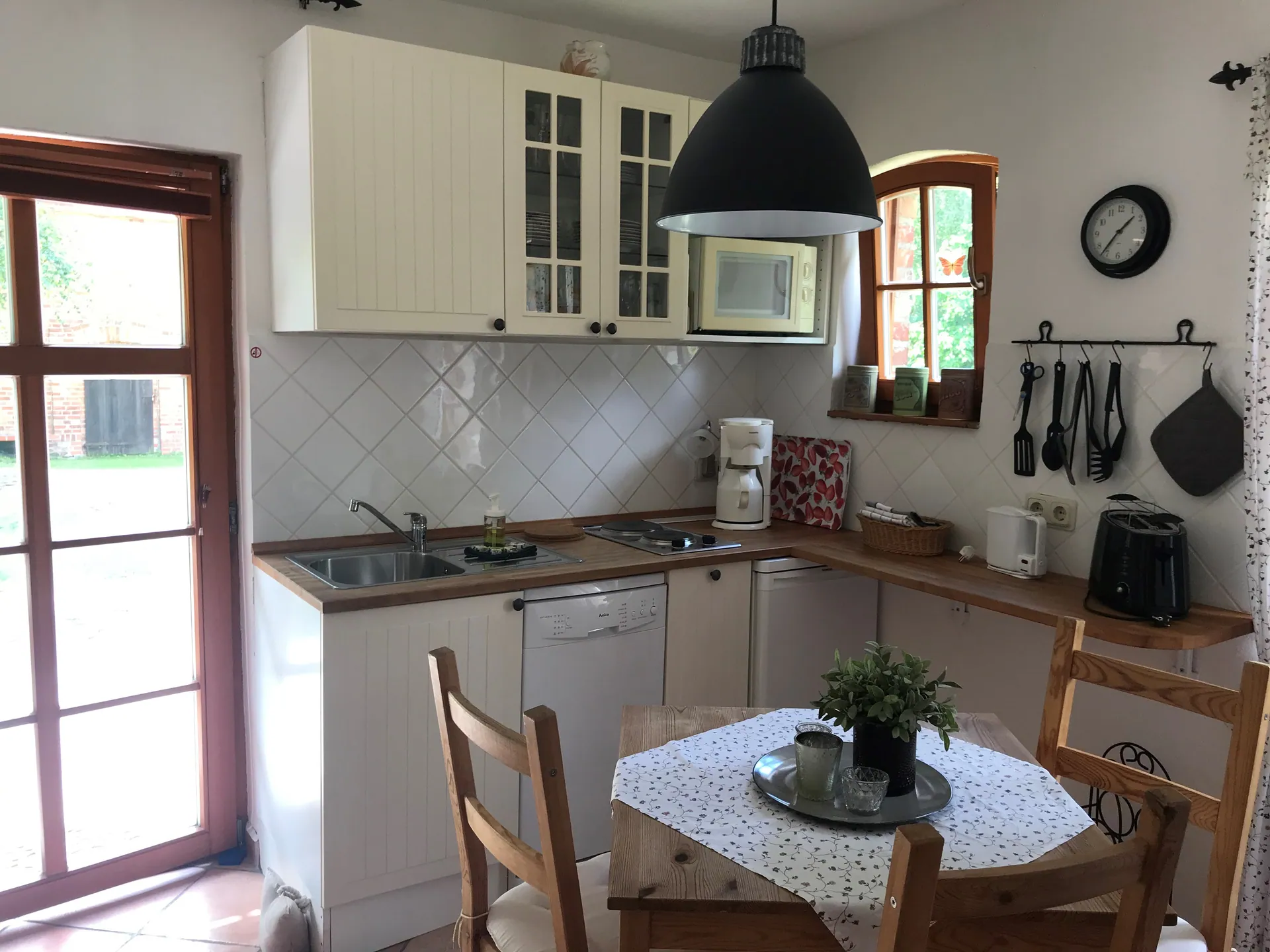 Ferienwohnung II: Einbauküche mit Essplatz und Tür zur Terrasse